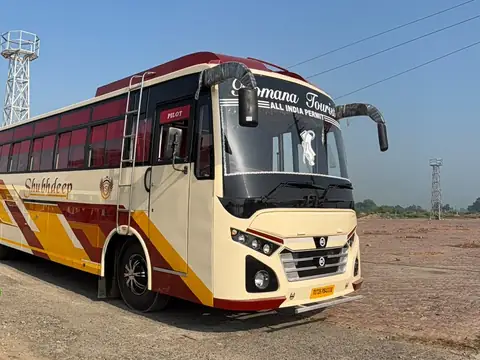 Deluxe coach, cream and maroon livery, front three-quarter view — built by Guru Kirpa Bus Body Builders, Barnala