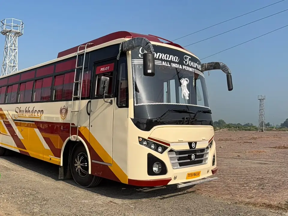 Deluxe coach, cream and maroon livery, front three-quarter view — built by Guru Kirpa Bus Body Builders, Barnala