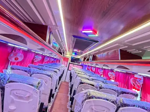 Deluxe coach, cream and maroon livery, interior with pushback seats — built by Guru Kirpa Bus Body Builders, Barnala