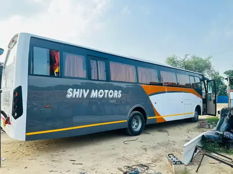 Deluxe coach, grey and orange livery, side view — built by Guru Kirpa Bus Body Builders, Barnala