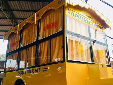 Palki Sahib with curtained cabin, side three-quarter view in our workshop — built by Guru Kirpa Bus Body Builders, Barnala