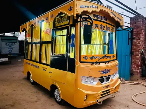 Palki Sahib on a mini bus chassis, front three-quarter view — built by Guru Kirpa Bus Body Builders, Barnala