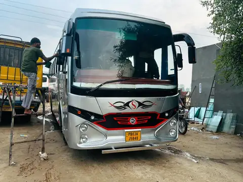 Ordinary bus, red with yellow graphics, finishing work on the front in our workshop — built by Guru Kirpa Bus Body Builders, Barnala