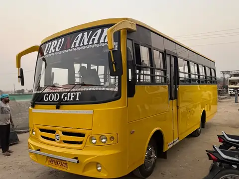School bus, yellow, front three-quarter view — built by Guru Kirpa Bus Body Builders, Barnala