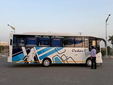 Volvo-type AC deluxe coach, white and blue livery, full side view — built by Guru Kirpa Bus Body Builders, Barnala